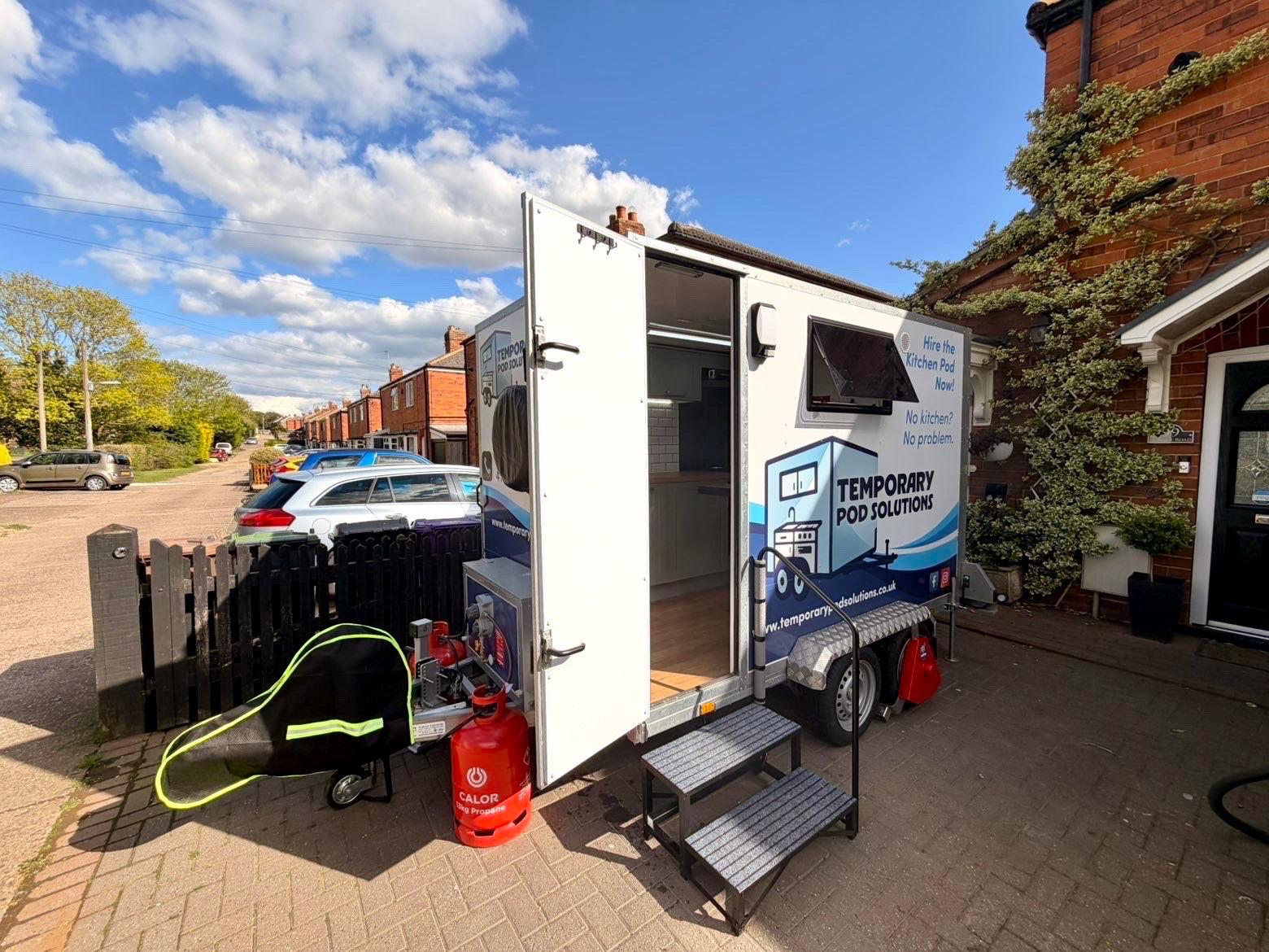Kitchen pod exterior with side door open on driveway